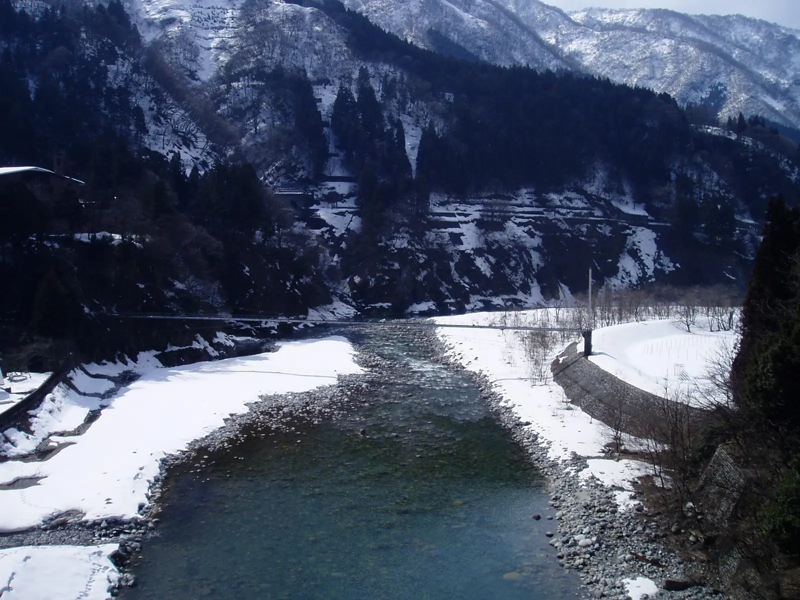 The Kurobe River flowing through a snow-covered gorge; the color of its pools changes with season and light.